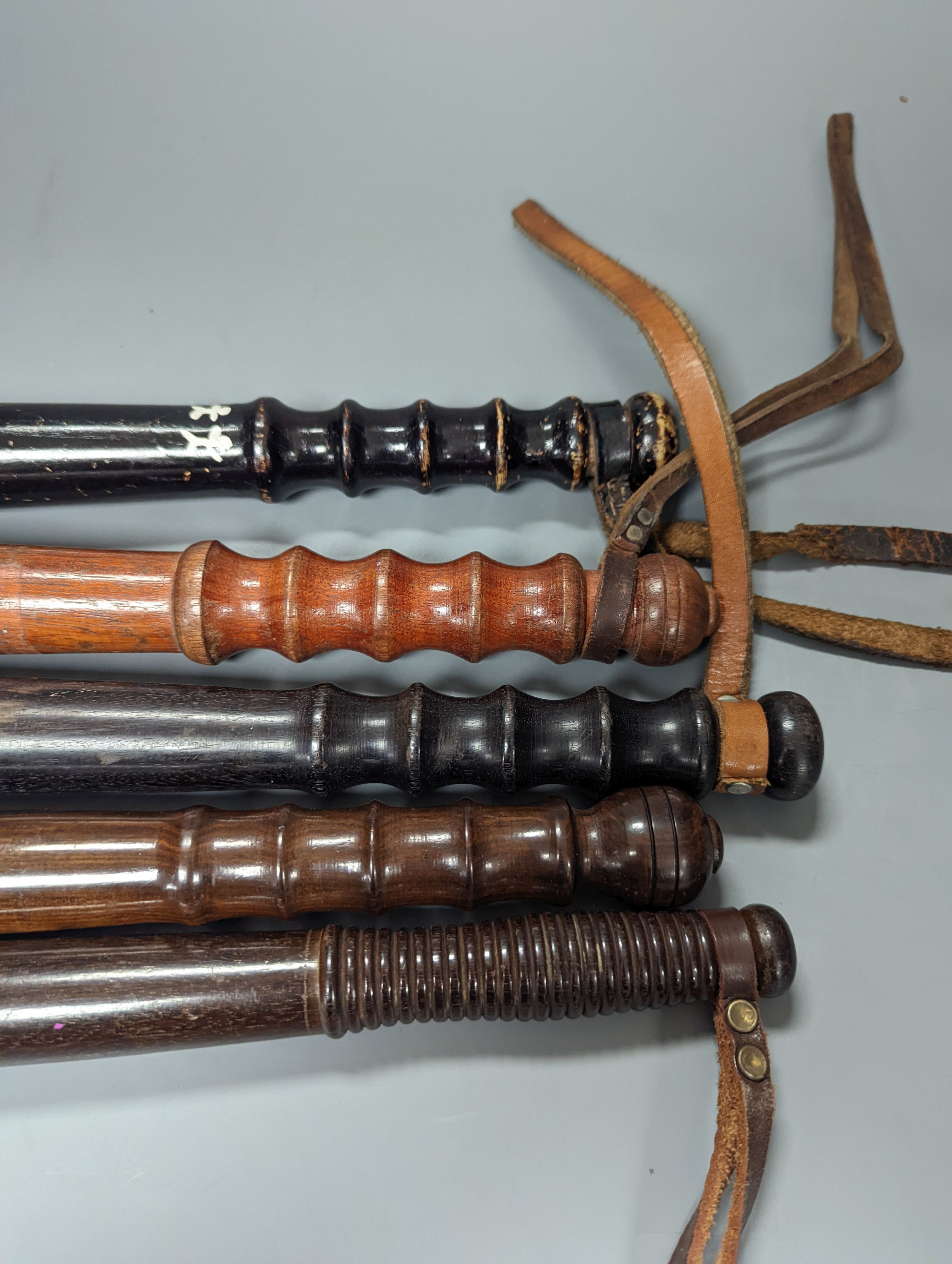 A collection of five 19th century and later wooden truncheons, largest 39 cms long.